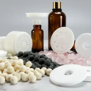 Fan diffuser consumable options including essential oil bottles, ceramic discs, polymer discs, scent pods, volcanic rocks, wooden beads, and crystal stones for flexible OEM fragrance systems